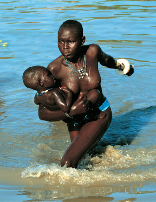 dinka women remove their clothing before entering the river, revealing their beaded jewelery.their belts and bracelets have been worn since puberty, while the necklaces were given by their husbands at the time of marriage.