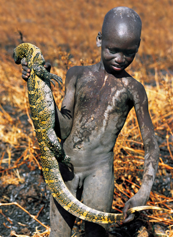 Young Dinka boys enjoy playing in the water after fishing. occasionally during the spearing of fish, monitor lizards or even pythons may be accidentally caught.