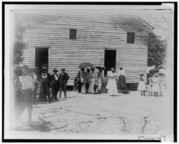 African Americans standing outside of a church