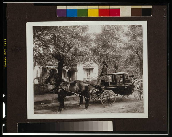 David Tobias Howard, an undertaker, his mother, and wife, Atlanta, Georgia; seated in a horse-drawn carriage with tree-shaded house in background