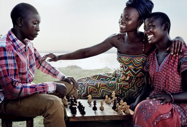 Lupita with her Queen of Katwe co-stars Martin Kabanza (far left) and Madina Nalwanga (far right). Lupita plays Harriet whose daughter Phiona becomes a chess prodigy.