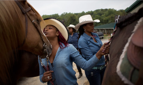 Pinky, Pennie (in background) and KB calm their horses before riding in the grand entry. Photograph: M Holden Warren